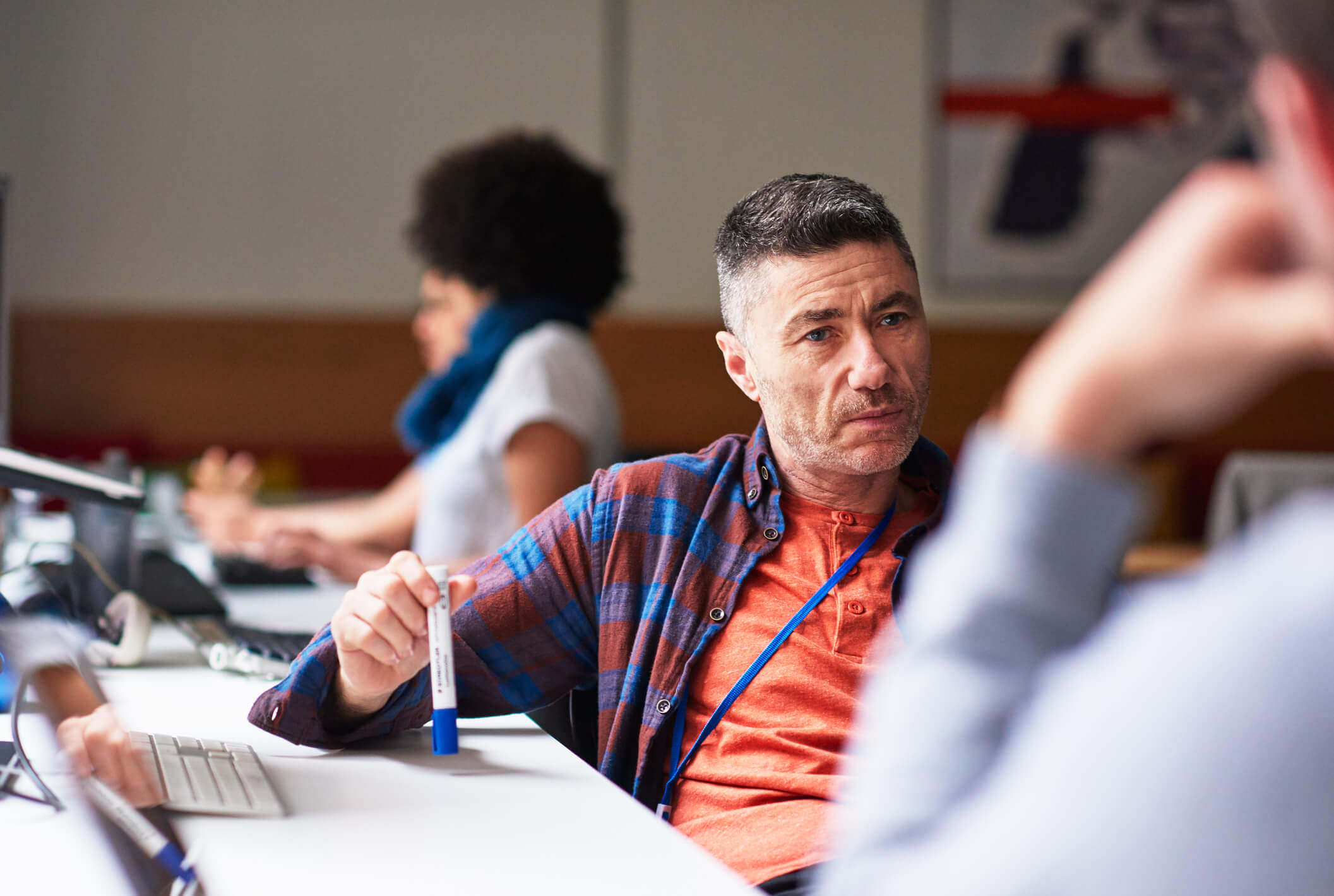 Eastern European man looking intently at his colleague